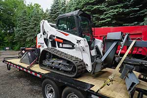 New condition Bobcat on trailer